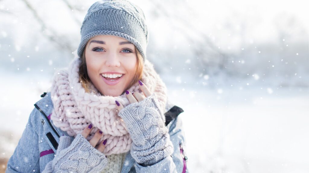 smiling woman wearing scarf and gloves